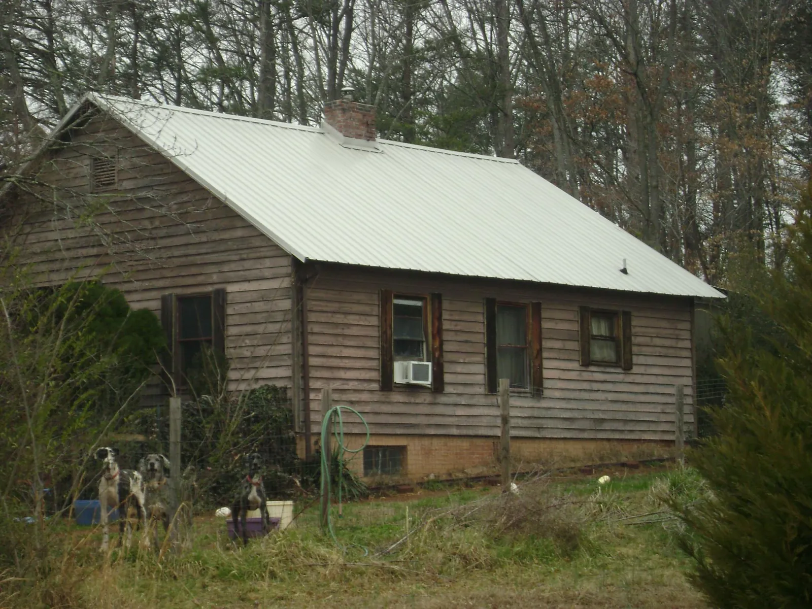 White metal roof on an old wood sided farmhouse, from a Metal Roof Installation job in Medon